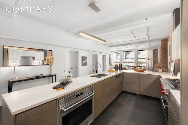 36 W 15th St Unit 4, New York City, NY 10011 - kitchen with oven, a sink, light countertops, and modern cabinets