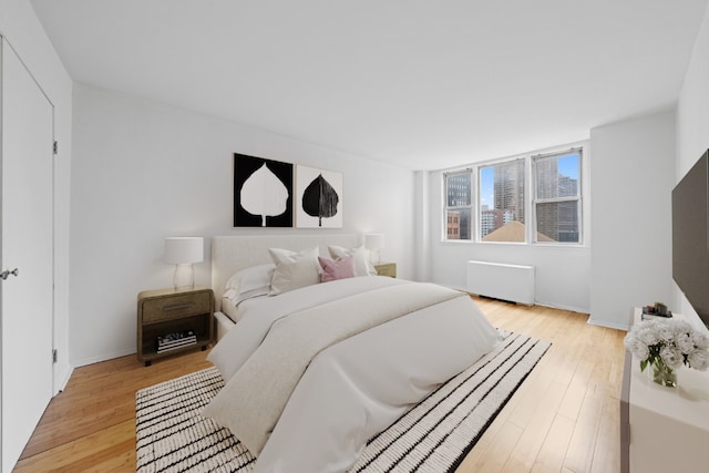 201 E 36th St Unit 14F, New York City, NY 10016 - bedroom with radiator and light wood-type flooring
