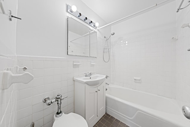 201 E 36th St Unit 14F, New York City, NY 10016 - full bath with vanity, tile walls, washtub / shower combination, tile patterned floors, and wainscoting