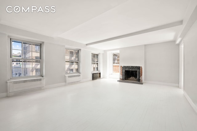 12 E 88th St Unit Ph11/12B, New York City, NY 10128 - unfurnished living room with a fireplace and baseboards