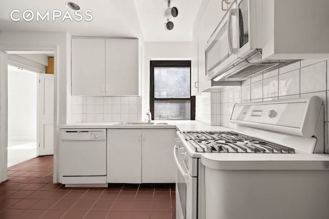 12 E 88th St Unit Ph11/12B, New York City, NY 10128 - kitchen featuring white appliances, light countertops, a sink, and dark tile patterned flooring