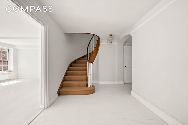 12 E 88th St Unit Ph11/12B, New York City, NY 10128 - stairway featuring arched walkways and baseboards