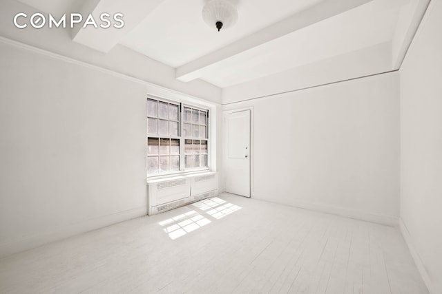 12 E 88th St Unit Ph11/12B, New York City, NY 10128 - spare room featuring beam ceiling, baseboards, and wood finished floors