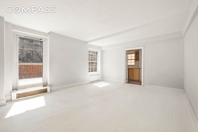 12 E 88th St Unit Ph11/12B, New York City, NY 10128 - unfurnished room with baseboards, wood finished floors, and a wall unit AC