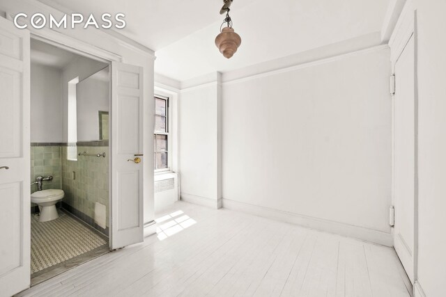 12 E 88th St Unit Ph11/12B, New York City, NY 10128 - bathroom with wood finished floors and tile walls
