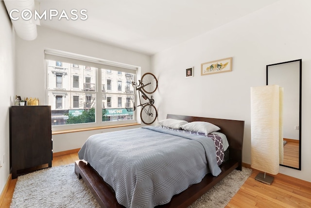 318 Knickerbocker Ave Unit 2A, New York City, NY 11237 - bedroom with wood finished floors, multiple windows, and baseboards