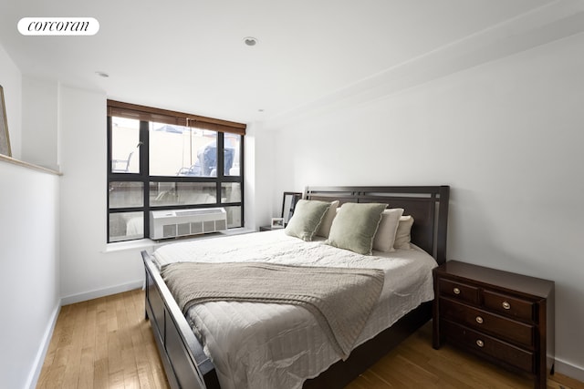 715 Prospect Pl Unit 1B, New York City, NY 11216 - bedroom with wood finished floors, baseboards, and cooling unit