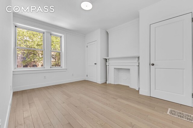 1050 Sterling Place, New York City, NY 11213 - unfurnished living room featuring light wood-style flooring, baseboards, and ornamental molding