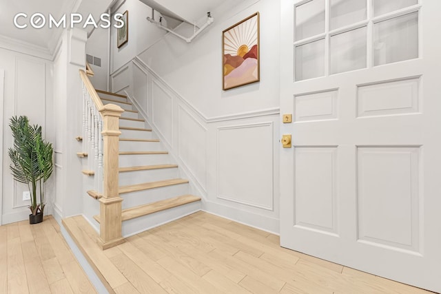 1050 Sterling Place, New York City, NY 11213 - foyer entrance with a decorative wall, wood finished floors, and stairs