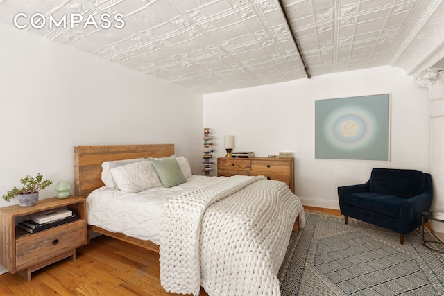 138 Broadway Unit 1D, New York City, NY 11211 - bedroom featuring wood finished floors, an ornate ceiling, and baseboards