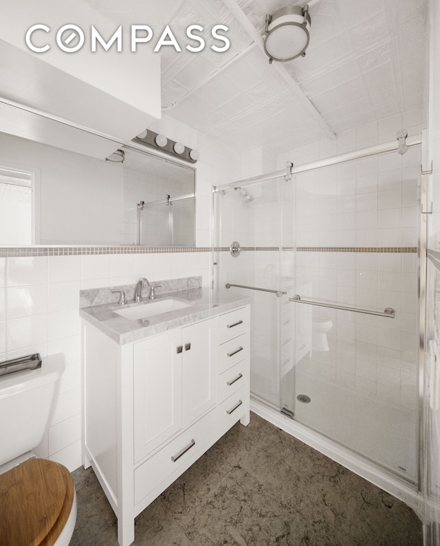 138 Broadway Unit 1D, New York City, NY 11211 - full bath with toilet, tile walls, vanity, and a stall shower