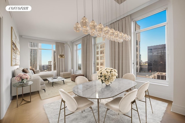 30 Park Pl Unit 60C, New York City, NY 10007 - dining space with a chandelier, a city view, and baseboards