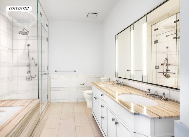 30 Park Pl Unit 60C, New York City, NY 10007 - full bathroom with tile walls, a shower stall, double vanity, toilet, and tile patterned flooring