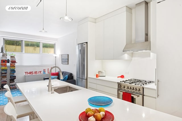 305 E 24th Street Lf, New York City, NY 10010 - kitchen with stainless steel appliances, modern cabinets, light countertops, pendant lighting, and a breakfast bar area