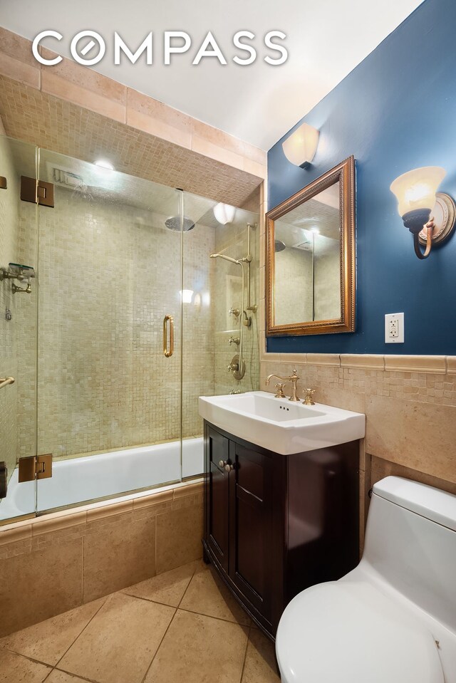 301 E 62nd St Unit 2K, New York City, NY 10065 - full bathroom with toilet, tiled shower / bath combo, tile walls, tile patterned floors, and vanity