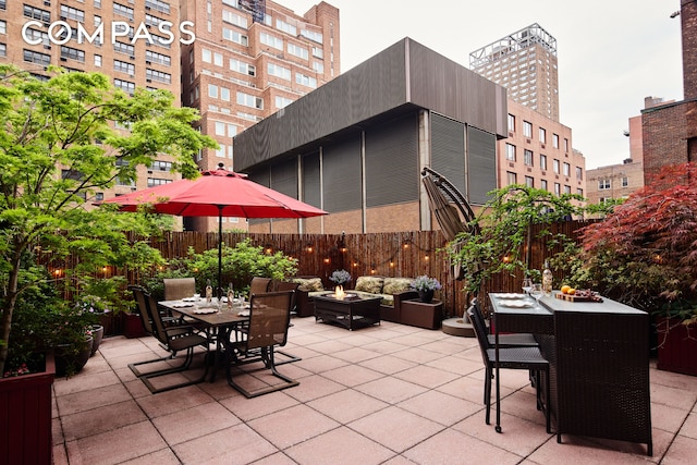301 E 62nd St Unit 2K, New York City, NY 10065 - view of patio featuring outdoor dining space and an outdoor living space with a fire pit