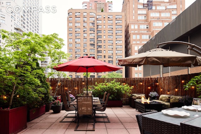 301 E 62nd St Unit 2K, New York City, NY 10065 - fenced backyard with a patio, an outdoor living space with a fire pit, and outdoor dining space