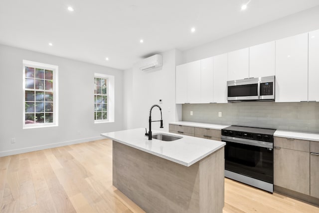 113 W 13th Street Building, New York City, NY 10011 - kitchen featuring black range with electric cooktop, stainless steel microwave, a sink, modern cabinets, and recessed lighting