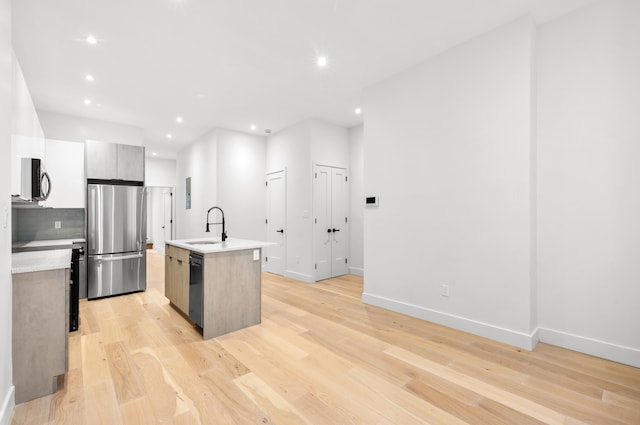 113 W 13th Street Building, New York City, NY 10011 - kitchen with stainless steel appliances, a sink, light countertops, modern cabinets, and a kitchen island with sink