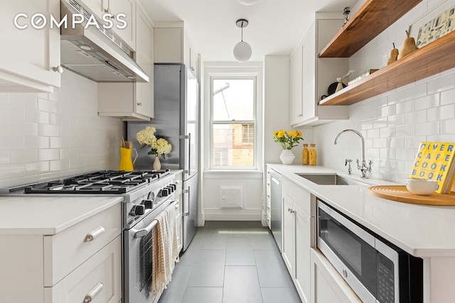 24 Monroe Pl Unit 7D, New York City, NY 11201 - kitchen with stainless steel appliances, under cabinet range hood, a sink, and backsplash