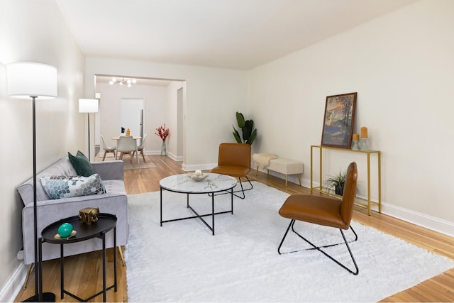 25 Indian Rd Unit 5G, New York City, NY 10034 - living area featuring a chandelier, wood finished floors, and baseboards