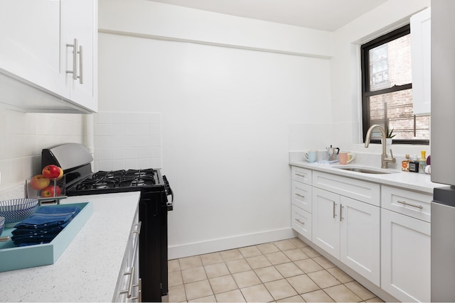 25 Indian Rd Unit 5G, New York City, NY 10034 - kitchen with a sink, stainless steel range with gas cooktop, backsplash, white cabinetry, and light tile patterned floors