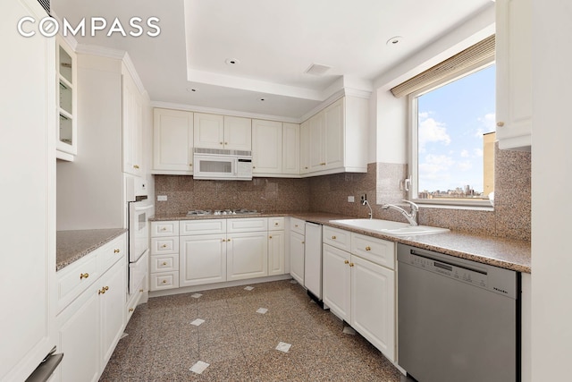 1049 5th Ave Unit Ph20, New York City, NY 10028 - kitchen with white appliances, a sink, white cabinetry, backsplash, and recessed lighting