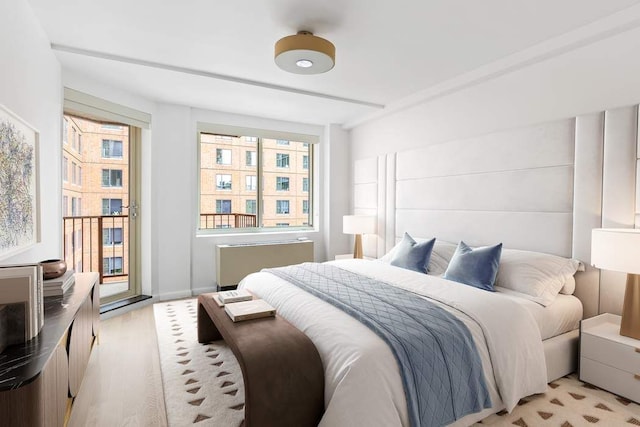 137 E 13th St Fl 9Th, New York City, NY 10003 - bedroom featuring radiator, access to exterior, and light wood-style floors