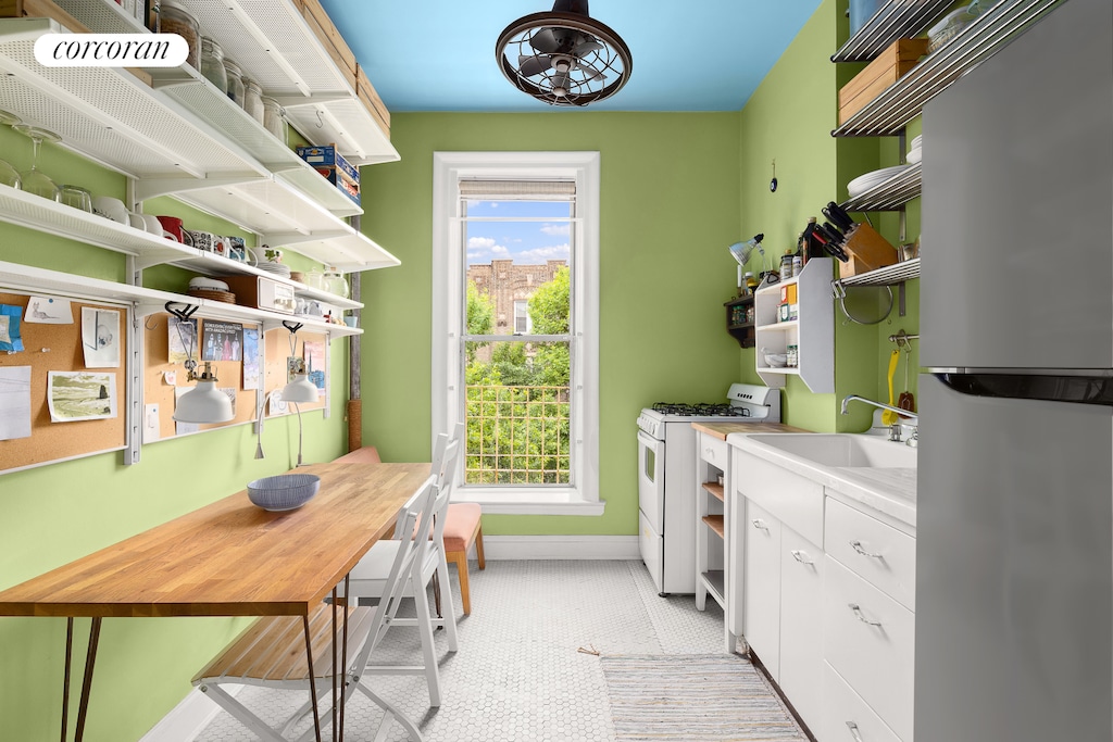 683 41st St Unit 26, New York City, NY 11232 - laundry area featuring baseboards, an office area, and plenty of natural light
