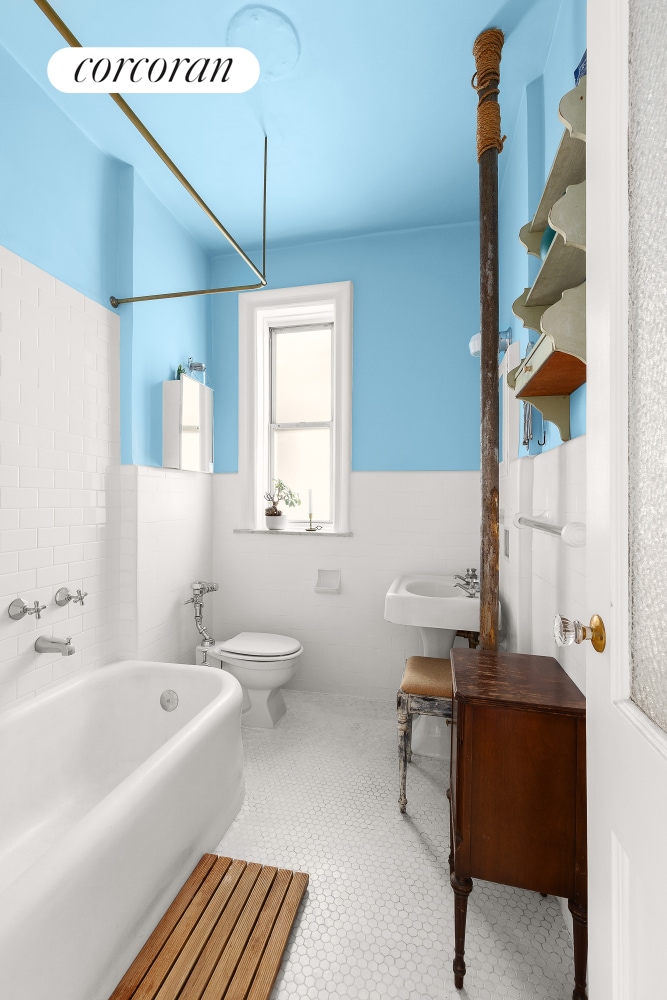 683 41st St Unit 26, New York City, NY 11232 - full bath with a sink, toilet, a wainscoted wall, and tile walls