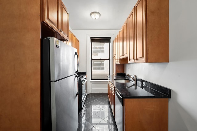 401 W End Ave Unit 6E, New York City, NY 10024 - kitchen featuring appliances with stainless steel finishes, brown cabinetry, and dark stone countertops