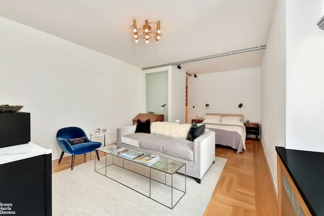 165 W 20th St Unit 6F, New York City, NY 10011 - living room featuring a chandelier and baseboards