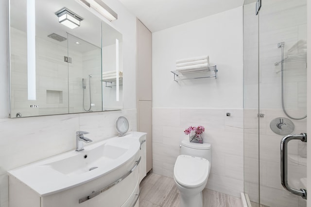 10 Bleecker St Unit 7A, New York City, NY 10012 - full bath featuring a shower stall, tile walls, vanity, and toilet