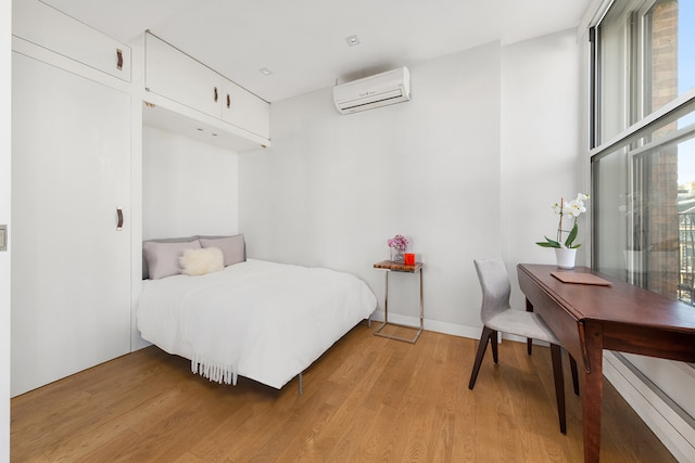 10 Bleecker St Unit 7A, New York City, NY 10012 - bedroom featuring a wall mounted air conditioner and light wood-style flooring