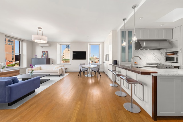 10 Bleecker St Unit 7A, New York City, NY 10012 - living area with light wood-type flooring, recessed lighting, and baseboards