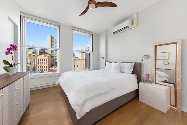 10 Bleecker St Unit 7A, New York City, NY 10012 - bedroom featuring light wood-style floors, an AC wall unit, and a ceiling fan