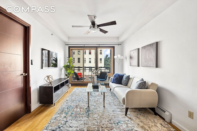 228 Bushwick Ave Unit 3B, New York City, NY 11206 - living room with a ceiling fan, a baseboard heating unit, and light wood-style flooring
