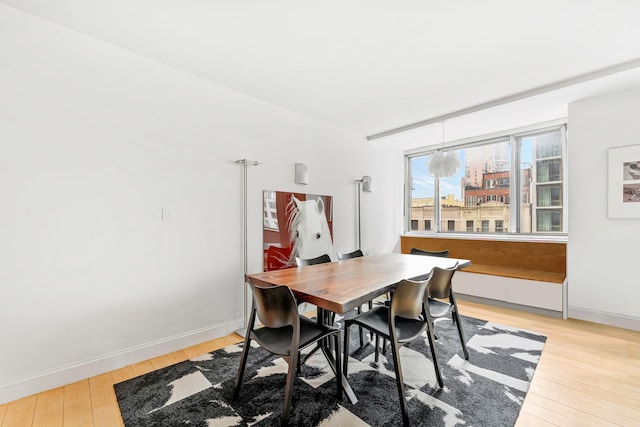 245 E 93rd St Unit 5Lm, New York City, NY 10128 - dining room with light wood-type flooring and baseboards