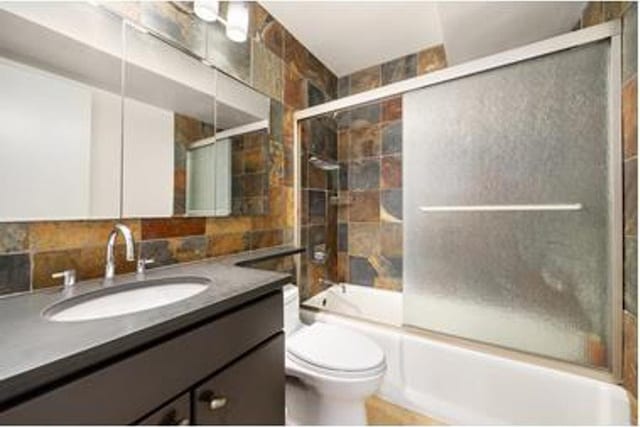 245 E 93rd St Unit 5Lm, New York City, NY 10128 - full bathroom featuring toilet, vanity, and combined bath / shower with glass door