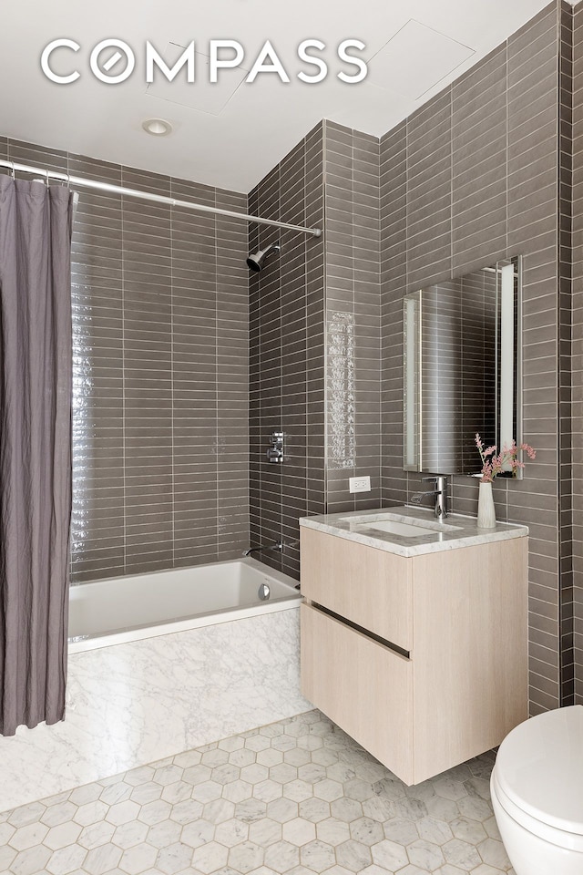 856 Washington Ave Unit 6A, New York City, NY 11238 - bathroom featuring shower / tub combo, vanity, and tile walls