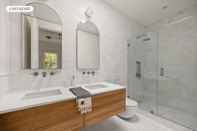 1498 Greene Ave, New York City, NY 11237 - bathroom with tile walls, vanity, a stall shower, toilet, and marble look tile flooring
