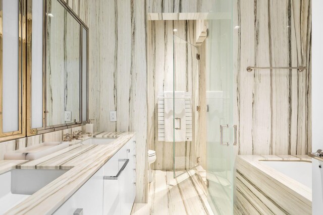 155 W 11th St Unit 14D, New York City, NY 10011 - bathroom featuring a garden tub, a marble finish shower, and double vanity