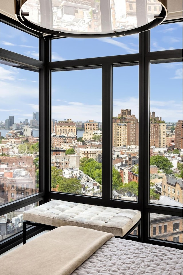 155 W 11th St Unit 14D, New York City, NY 10011 - unfurnished bedroom featuring a city view, multiple windows, and expansive windows
