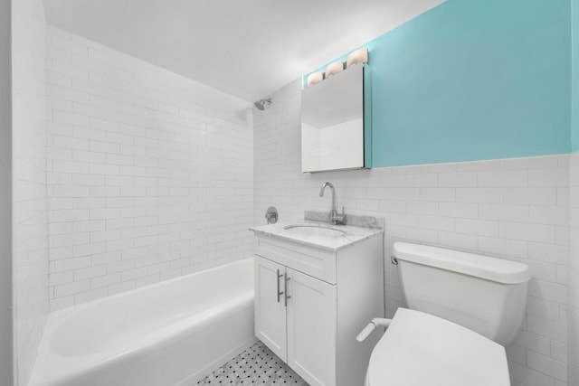 220 E 67th St Unit 11F, New York City, NY 10065 - bathroom featuring vanity, shower / bath combination, toilet, and tile walls