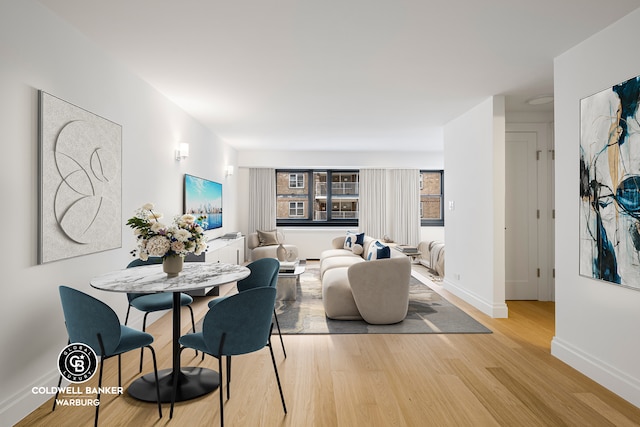 235 E 87th St Unit 7E, New York City, NY 10128 - dining area with wood finished floors and baseboards