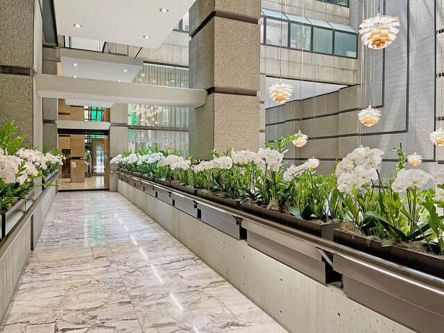 117 E 57th St Unit 35/36F, New York City, NY 10022 - view of community featuring a towering ceiling and recessed lighting