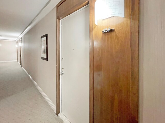 117 E 57th St Unit 35/36F, New York City, NY 10022 - hallway featuring light colored carpet and baseboards
