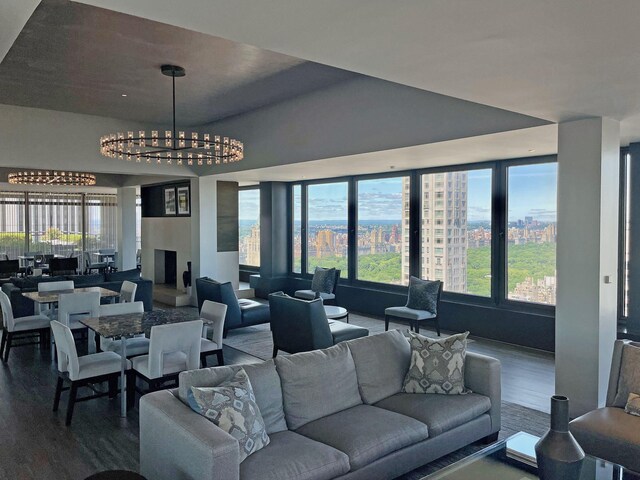 117 E 57th St Unit 35/36F, New York City, NY 10022 - living area featuring a chandelier, dark wood-style floors, and plenty of natural light