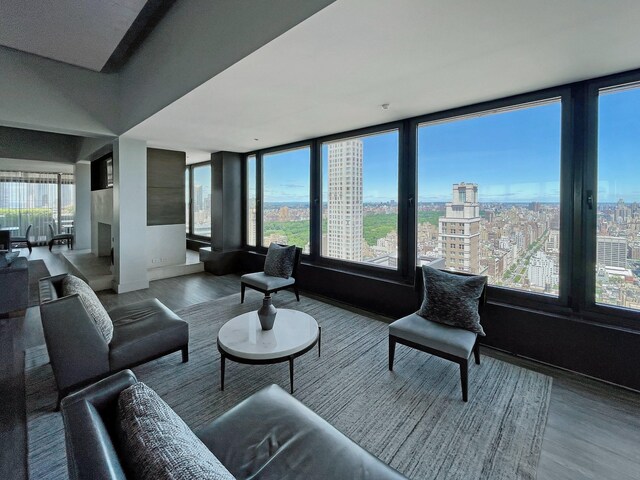 117 E 57th St Unit 35/36F, New York City, NY 10022 - living area featuring wood finished floors, a city view, and baseboards