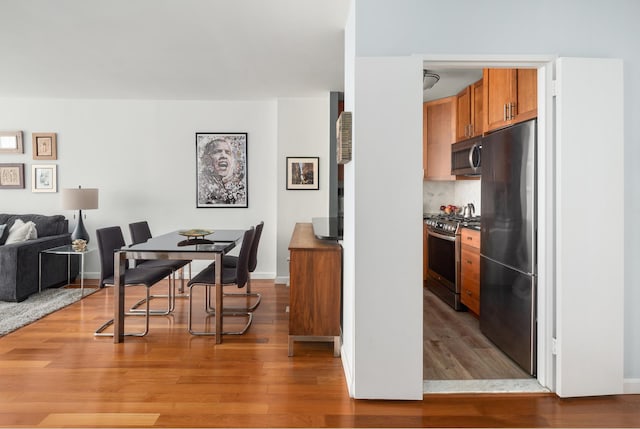 200 W 79th St Unit 9J, New York City, NY 10024 - dining area featuring light wood-style floors and baseboards